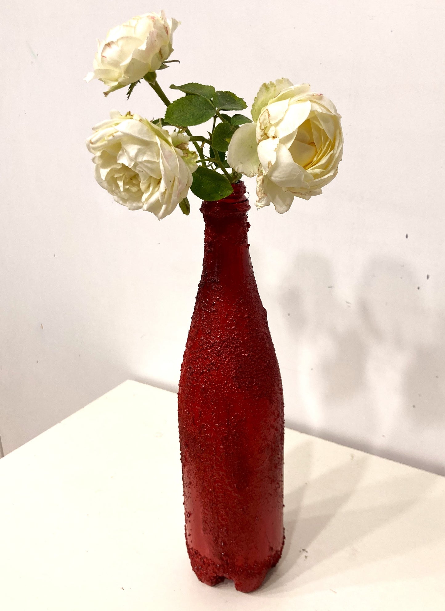 Recycled plastic bottle vase , Acrylic Painted , Sand sprinkled Red Vase for dried flowers. [Recycled Art]. Right Lateral view