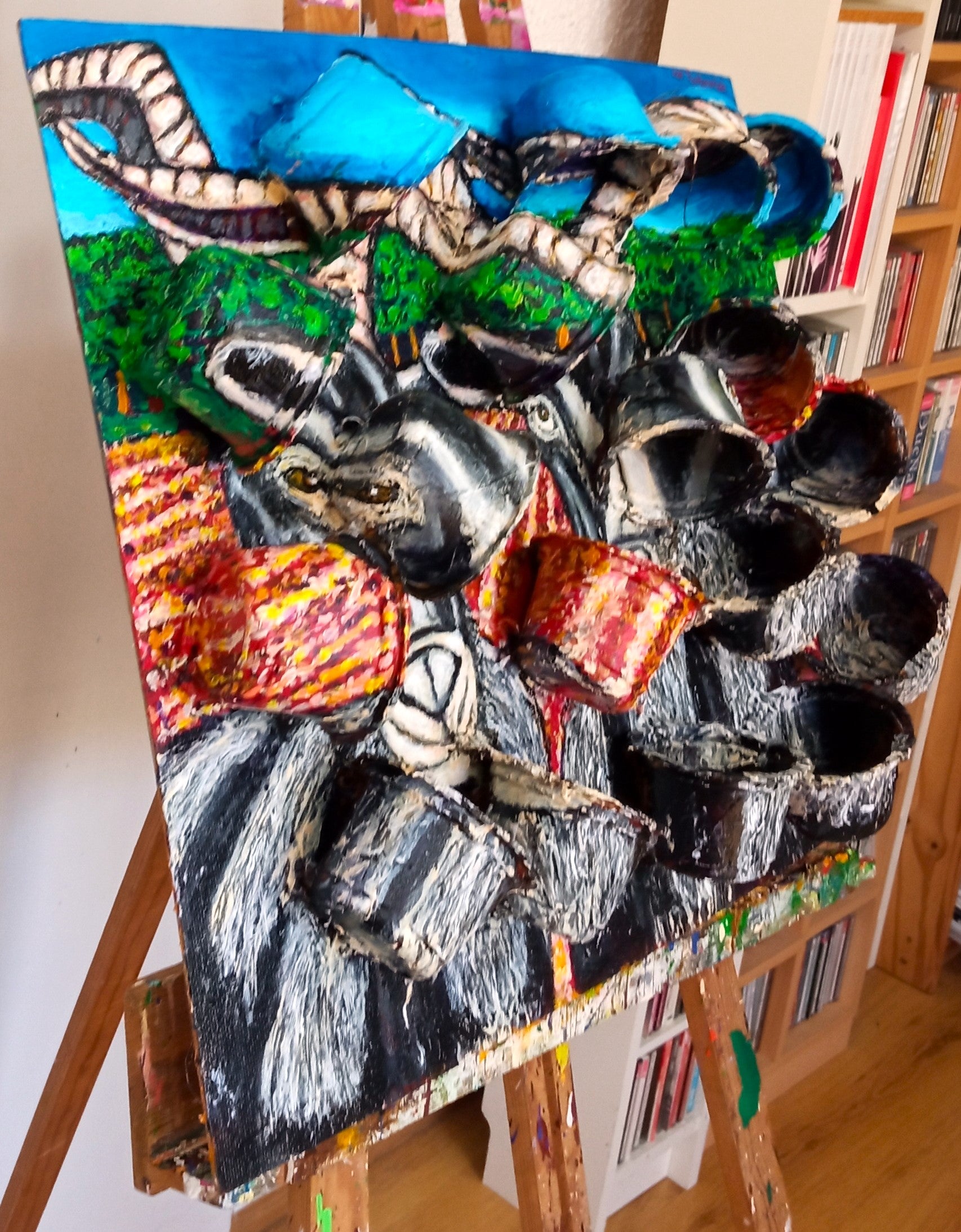 3D portrait of three male goats in a field with a pinetree forest in the background. Acrylic paint on woodboard and recycled plastic rice containers.[Recycled Art]. Left Lateral View