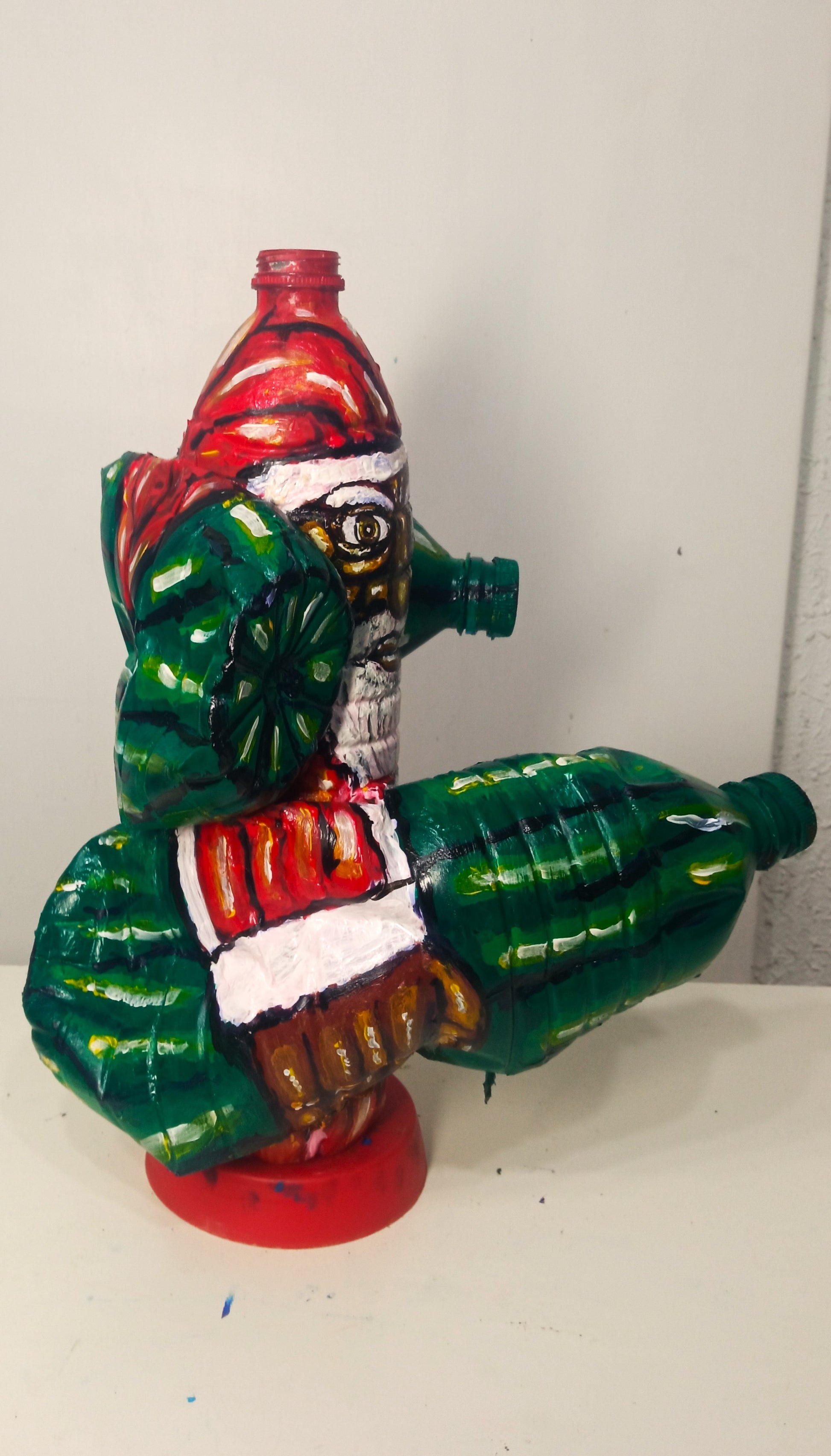 Black Santa Carrying Bottles Created out of Recycled Plastic Bottles . [Recycled Art]. Ivan Fyodorovich. Left lateral view