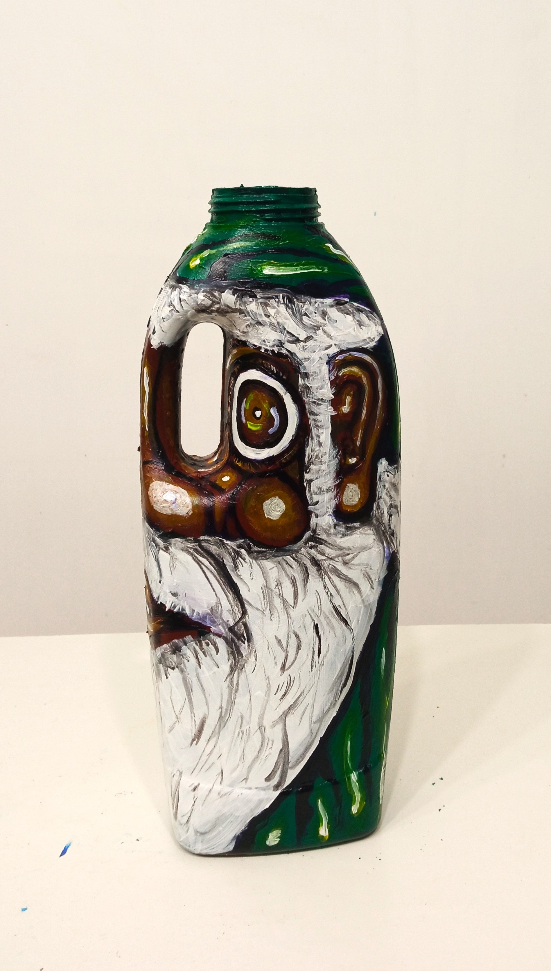 Black Santa Claus Wearing a Green Costume Created out of Recycled Plastic Bottle . [Recycled Art]. Ivan Fyodorovich. Right side view