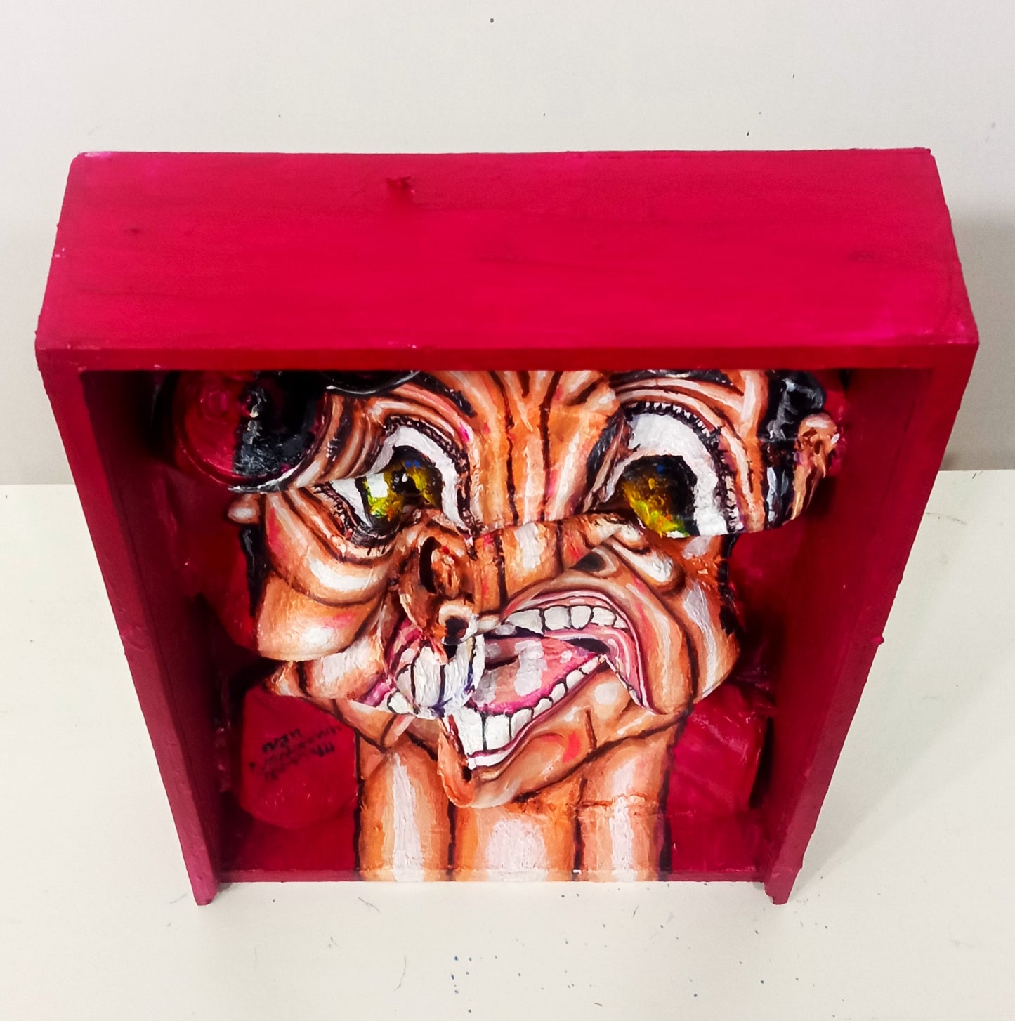 3D Streetart expressionistic style portrait painting.Anguished man with panic attack portrait. Acrylic on Wood box and Recycled beer Cans. [Recycled Art]. Cenital View