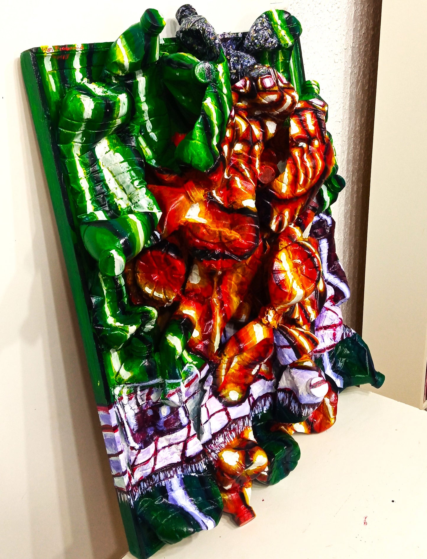 "Depression" 3D Portrait of a drinking man. Acrylic on recycled plastic bottles. [Recycled Art]. Left lateral view